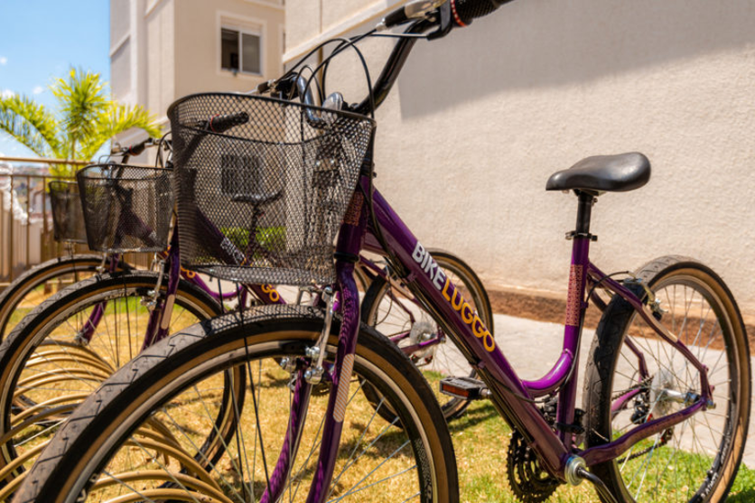 Bicicletário de empreendimento Luggo, com bicicletas roxas com os escritos “BIKE LUGGO”.